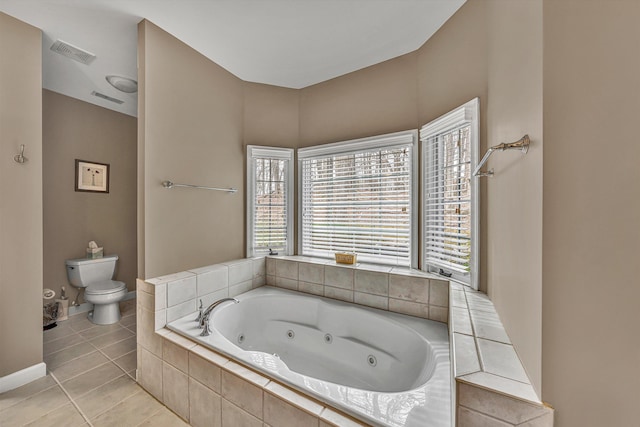 full bath featuring tile patterned floors, toilet, a tub with jets, and visible vents