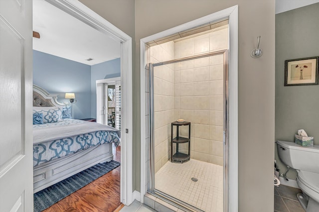 ensuite bathroom with visible vents, ensuite bath, a stall shower, tile patterned flooring, and toilet