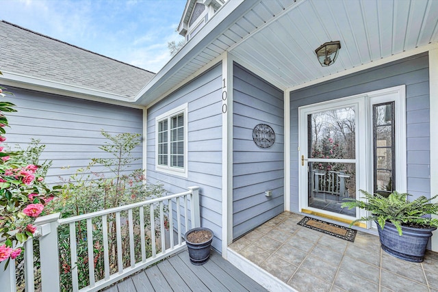 property entrance with a shingled roof