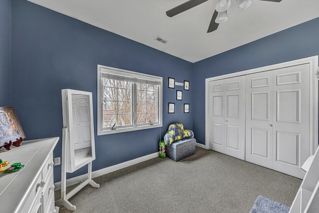 interior space with visible vents, carpet floors, baseboards, and ceiling fan