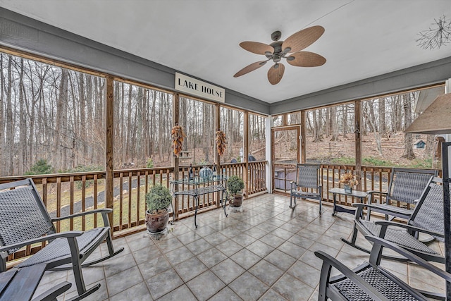 unfurnished sunroom featuring ceiling fan