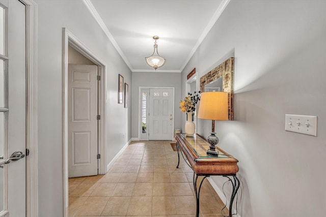 foyer featuring light tile patterned floors, baseboards, and ornamental molding