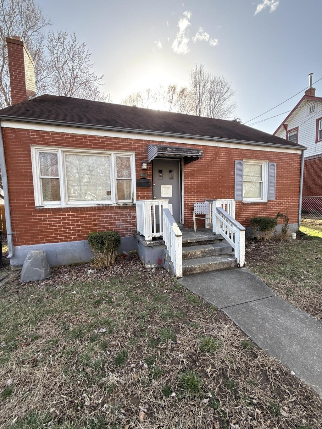 623 Arbutus Ave SE, Roanoke, VA 24014 - view of front of house with brick siding, a chimney, and a front yard