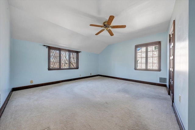 bonus room with baseboards, visible vents, a ceiling fan, vaulted ceiling, and carpet flooring