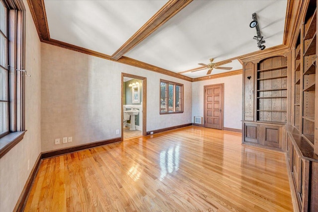 unfurnished living room featuring light wood-type flooring, a healthy amount of sunlight, baseboards, and visible vents