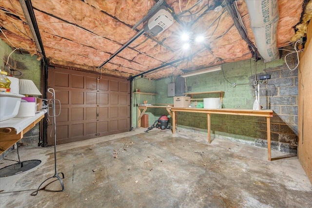 garage with concrete block wall and a garage door opener