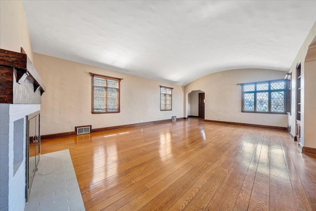 unfurnished living room with baseboards and hardwood / wood-style flooring