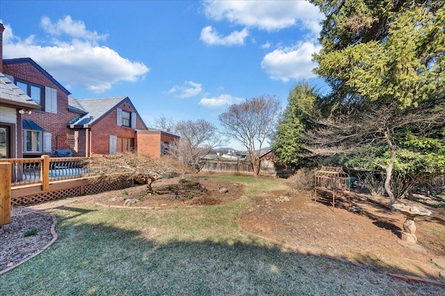 view of yard with fence and a wooden deck