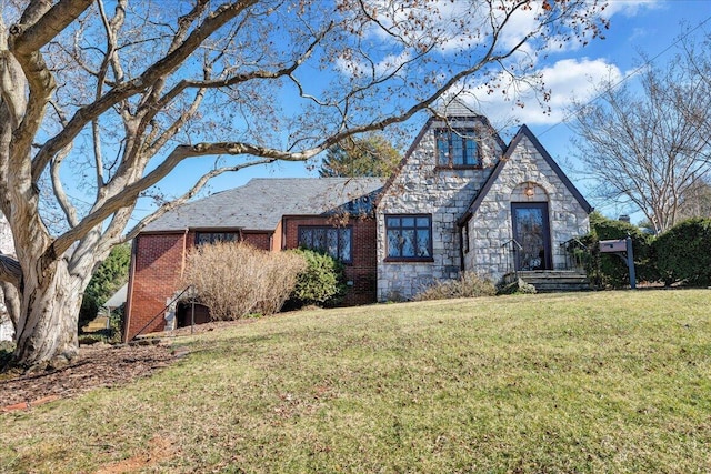 view of front facade featuring stone siding, brick siding, and a front lawn