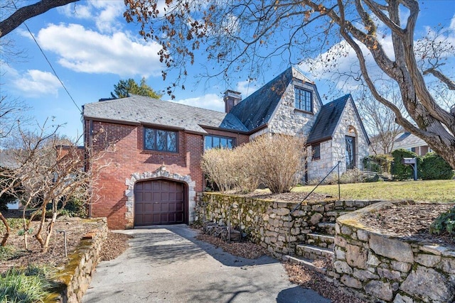 view of front of home featuring aphalt driveway, brick siding, stone siding, a chimney, and a high end roof