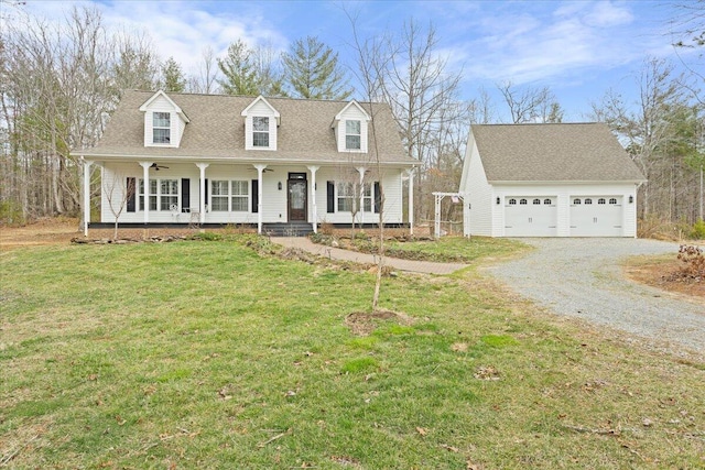 cape cod-style house with roof with shingles, covered porch, an outdoor structure, and a front yard