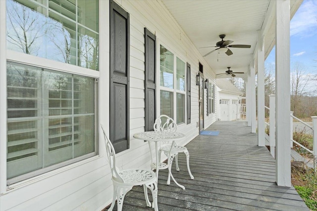 deck with a porch and ceiling fan