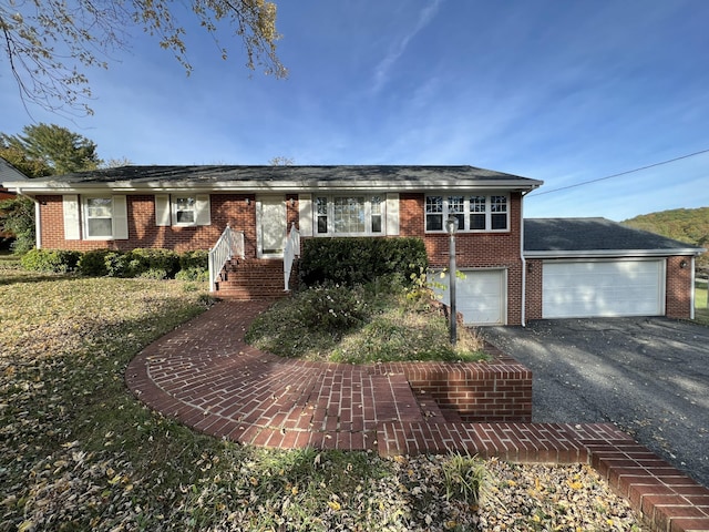 single story home featuring brick siding, driveway, and an attached garage