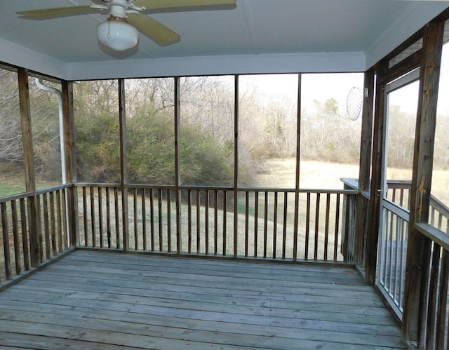 unfurnished sunroom with a ceiling fan