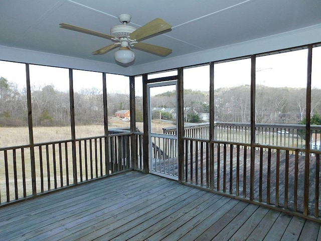 unfurnished sunroom with a ceiling fan