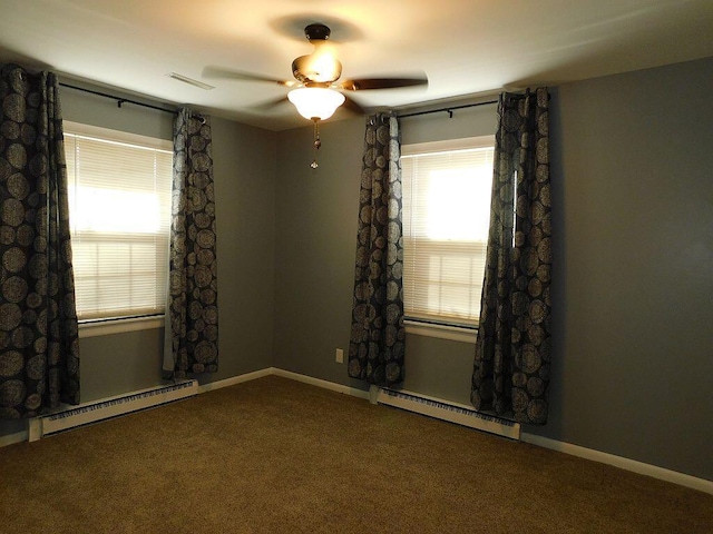 carpeted spare room featuring a baseboard heating unit, visible vents, a ceiling fan, and baseboards