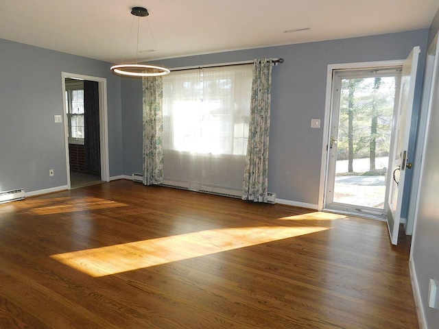 unfurnished dining area featuring baseboards and wood finished floors