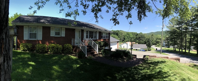 view of front of house with a front lawn and brick siding