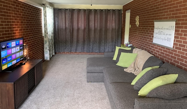 carpeted living room featuring brick wall