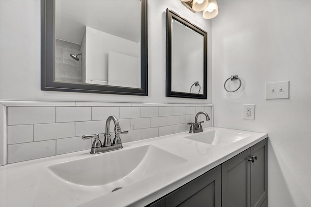 bathroom with a sink, backsplash, and double vanity