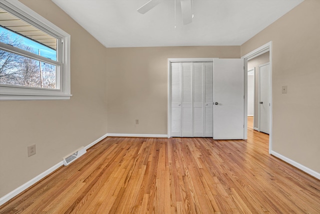 unfurnished bedroom with light wood-type flooring, visible vents, and baseboards