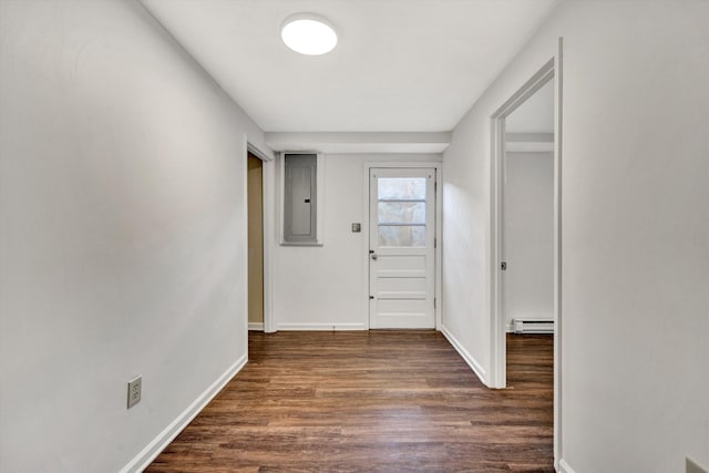 foyer entrance featuring a baseboard radiator, electric panel, baseboards, and dark wood-style flooring