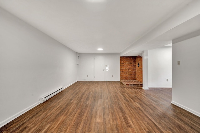 unfurnished living room with baseboards, baseboard heating, and dark wood-style flooring