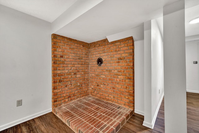 interior space with baseboards and wood finished floors