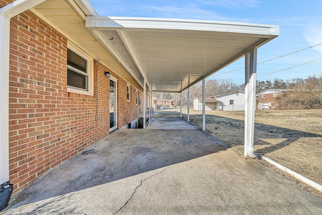 view of patio featuring a carport and concrete driveway