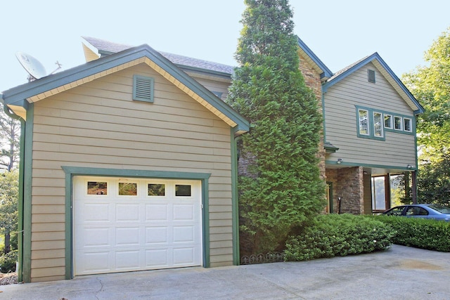 368 Penninsula Pt, Lynch Station, VA 24571 - view of property exterior with driveway, a garage, and stone siding
