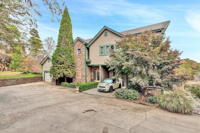 368 Penninsula Pt, Lynch Station, VA 24571 - view of front facade with a garage, concrete driveway, and stone siding