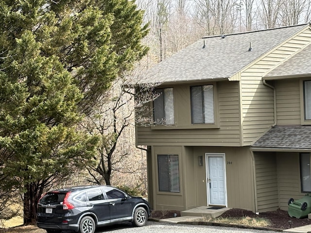 view of front of property featuring roof with shingles