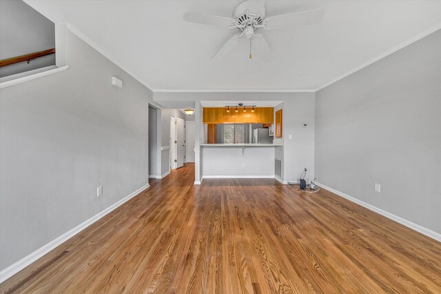 unfurnished living room featuring light colored carpet, visible vents, a stone fireplace, and baseboards