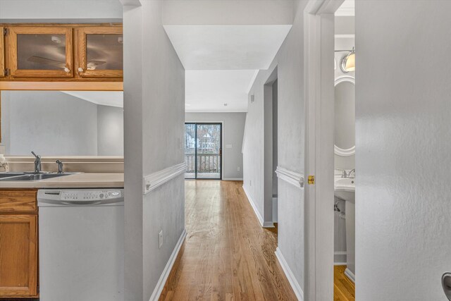 empty room with ceiling fan, baseboards, crown molding, and wood finished floors