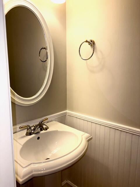 bathroom with wainscoting and a sink