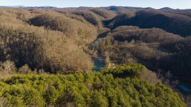 birds eye view of property with a view of trees