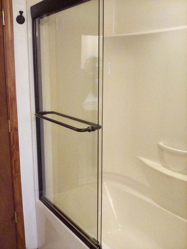 full bathroom with a tub to relax in and a shower with door