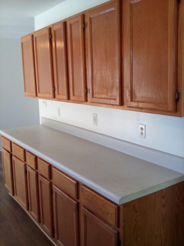 kitchen featuring brown cabinetry and light countertops