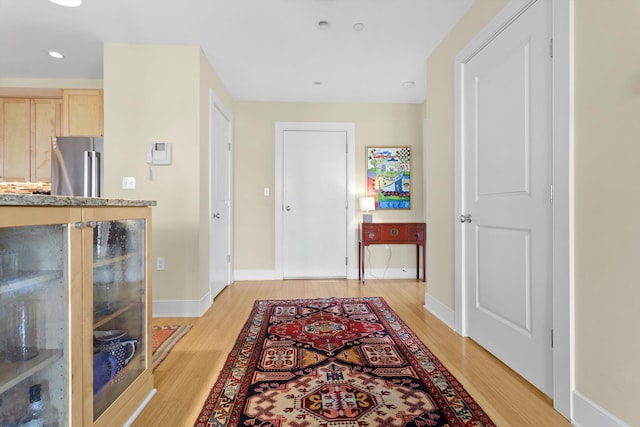 foyer entrance with recessed lighting, baseboards, and light wood finished floors