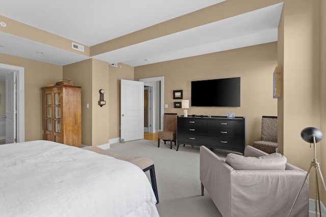 bedroom featuring light carpet, baseboards, and visible vents