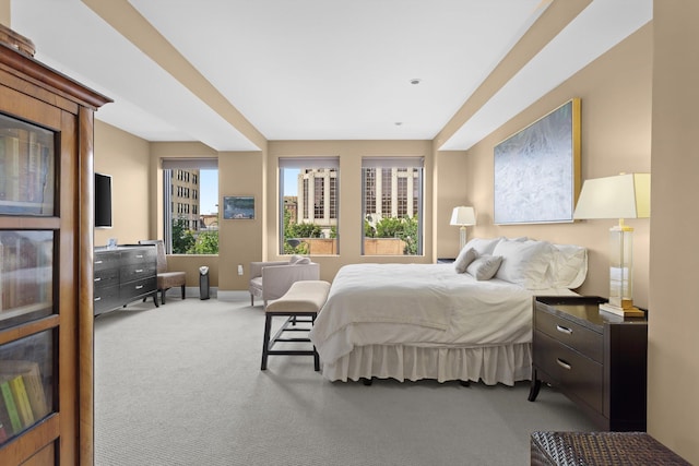 bedroom featuring carpet flooring, baseboards, and multiple windows