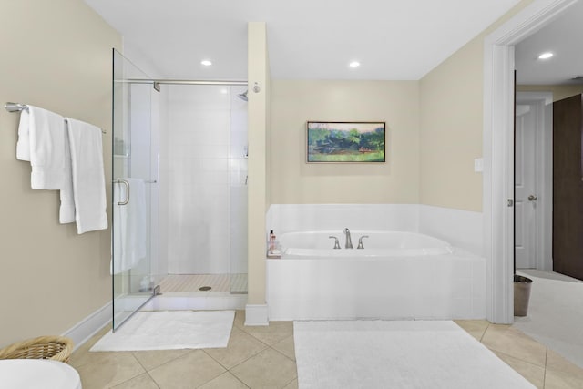 bathroom with a stall shower, recessed lighting, a bath, and tile patterned floors