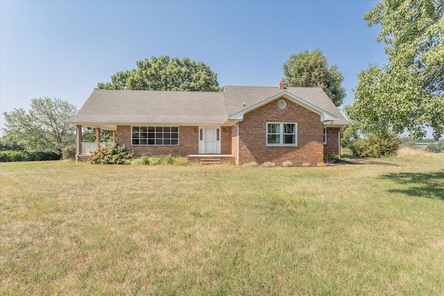 ranch-style house with brick siding, a chimney, and a front lawn