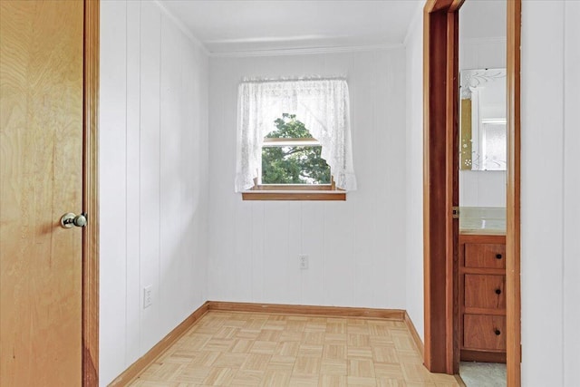 spare room featuring baseboards and ornamental molding