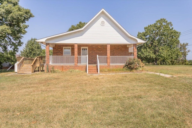 bungalow-style home featuring a porch, brick siding, and a front lawn