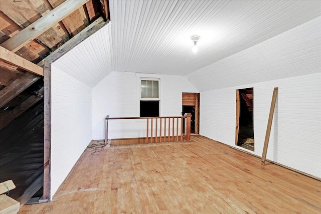 bonus room featuring lofted ceiling and wood-type flooring