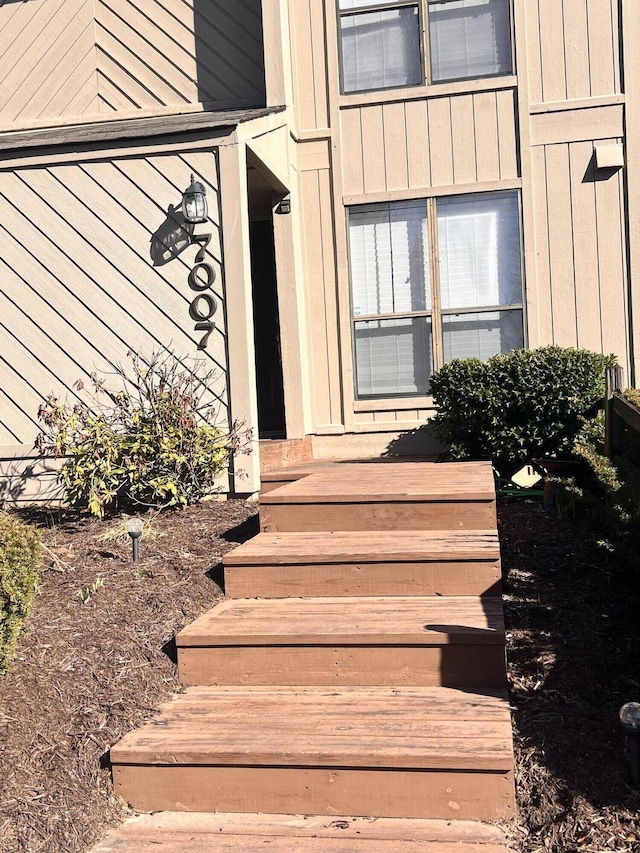 doorway to property featuring board and batten siding