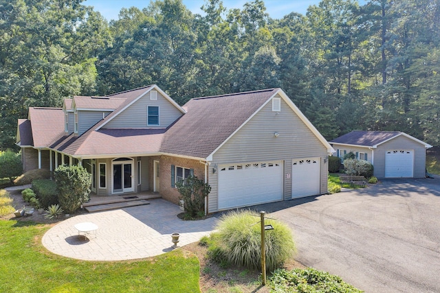 view of front of house featuring a porch, a wooded view, and brick siding