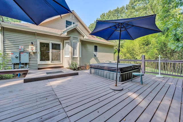 wooden terrace with a covered hot tub