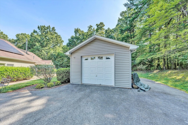 detached garage featuring driveway